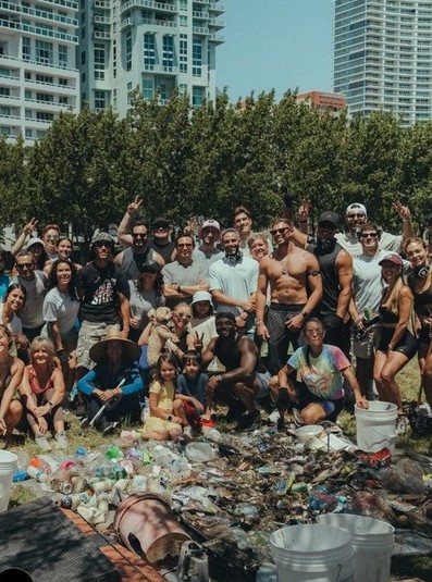 A group photo taken behind the full haul of trash collected that morning