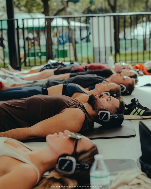Volunteers lying on mats during the yoga flow that opens each cleanup